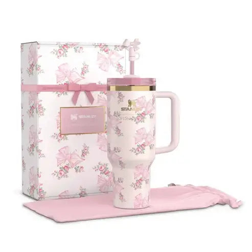 Floral-patterned mug with pink handle and matching pink box on a white background