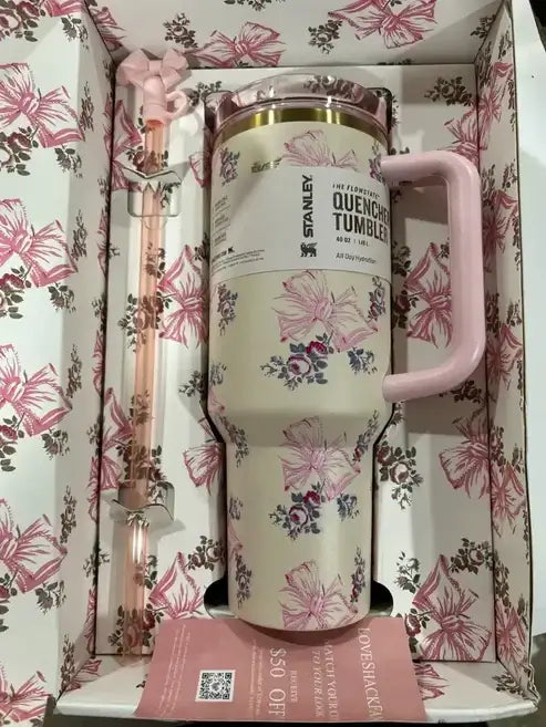 Floral-patterned tumbler with pink handle in a decorative box