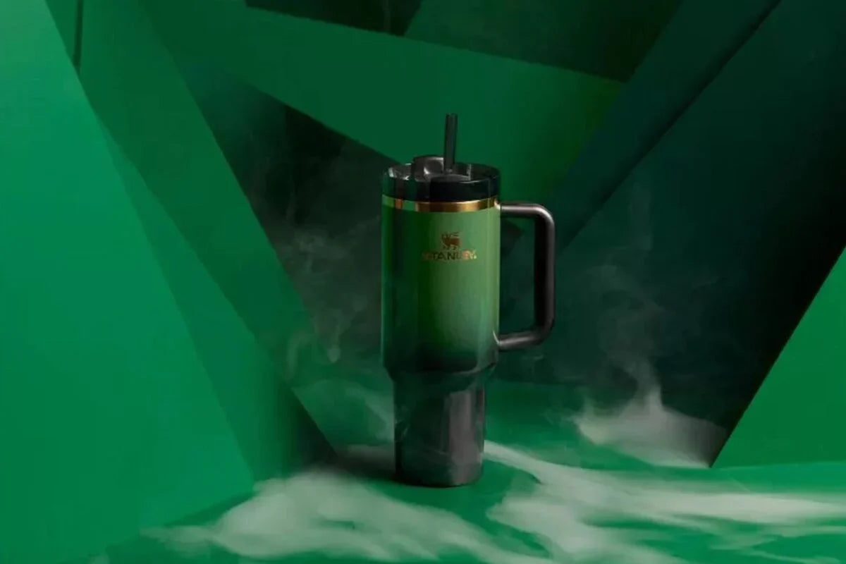 Green mug with gold accents on a green background EA Supplements